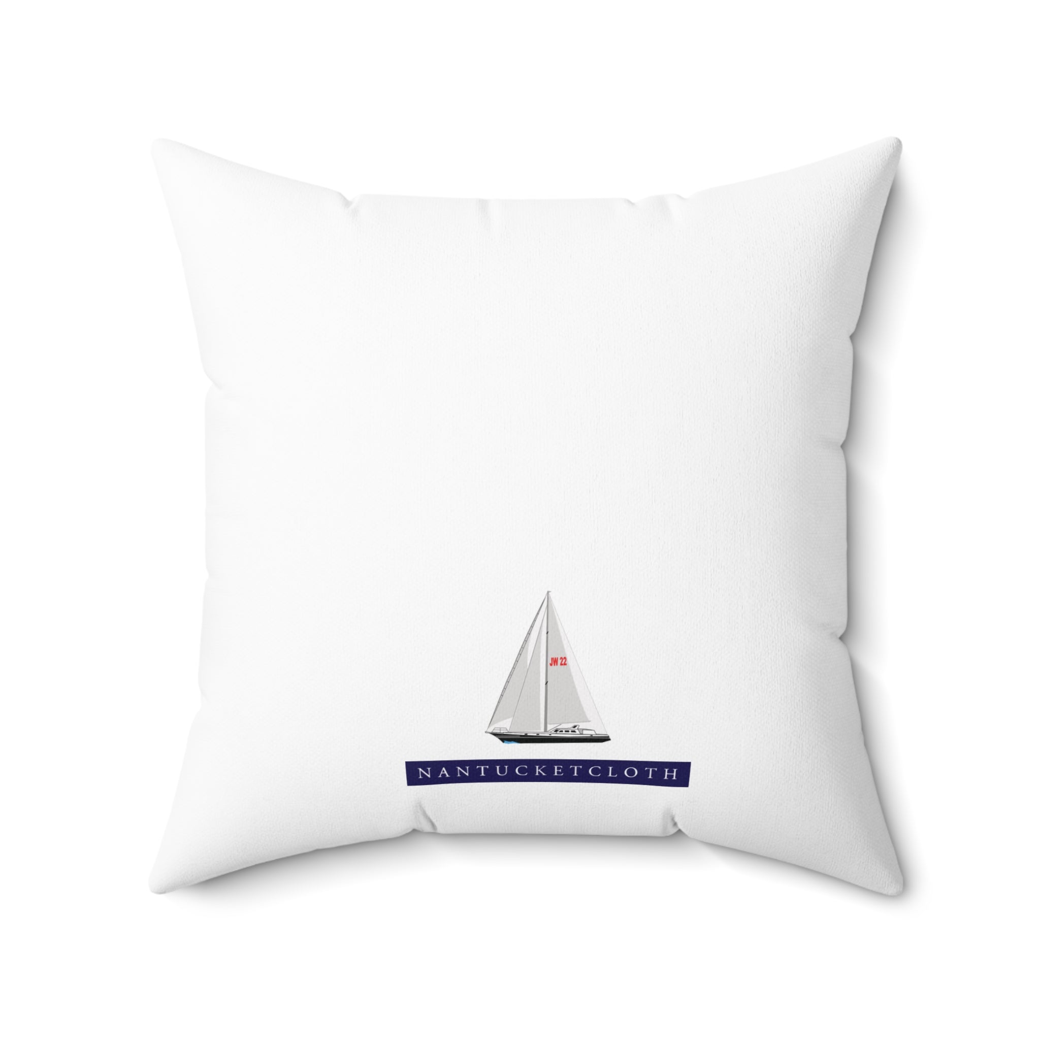 White pillow with sailboat design and 'Nantucket Cloth' text on a white background